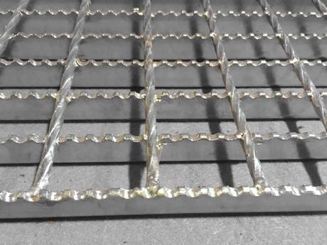 a part of serrated galvanized steel grating